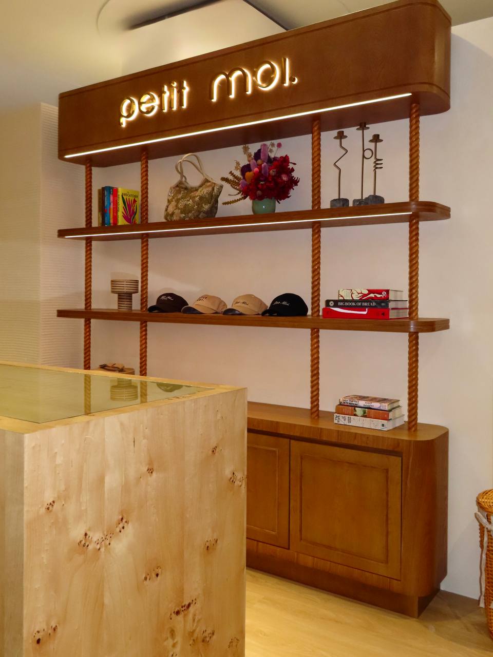 Petit Moi Isetan KLCC timber display shelves, illuminated signage and stone counter